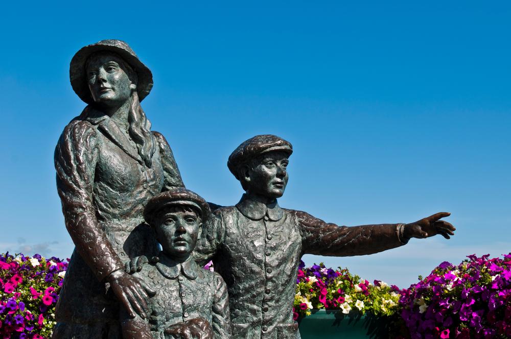 A statue of Annie Moore and her two young brothers stands near the harbor in Cobh, Ireland