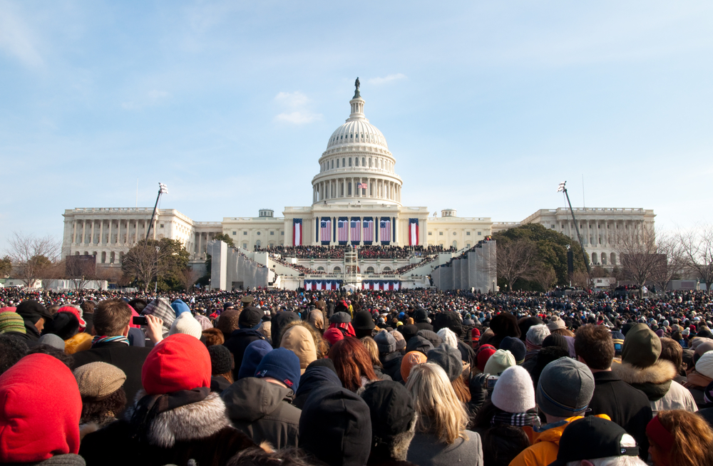 A crowd of thousands stands in front of the U.S. Capitol, watching the inauguration of the newest president